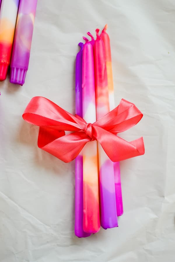 Colourful candles tied together with a bow