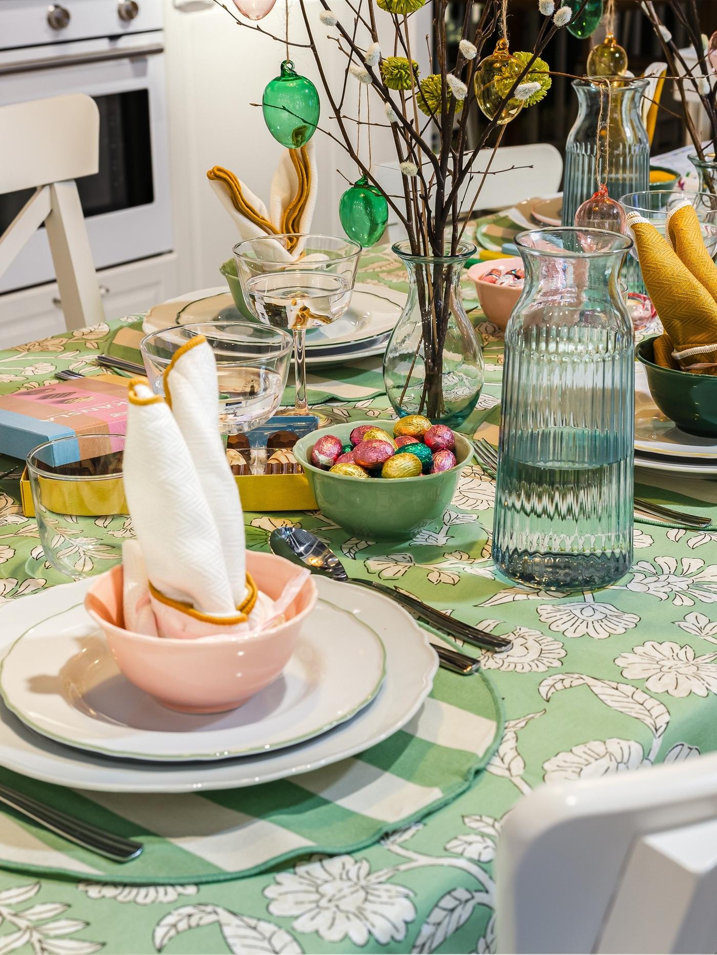 Colourful felt-tip pens placed on an Easter-themed colouring page, suggesting a creative activity at the table.
