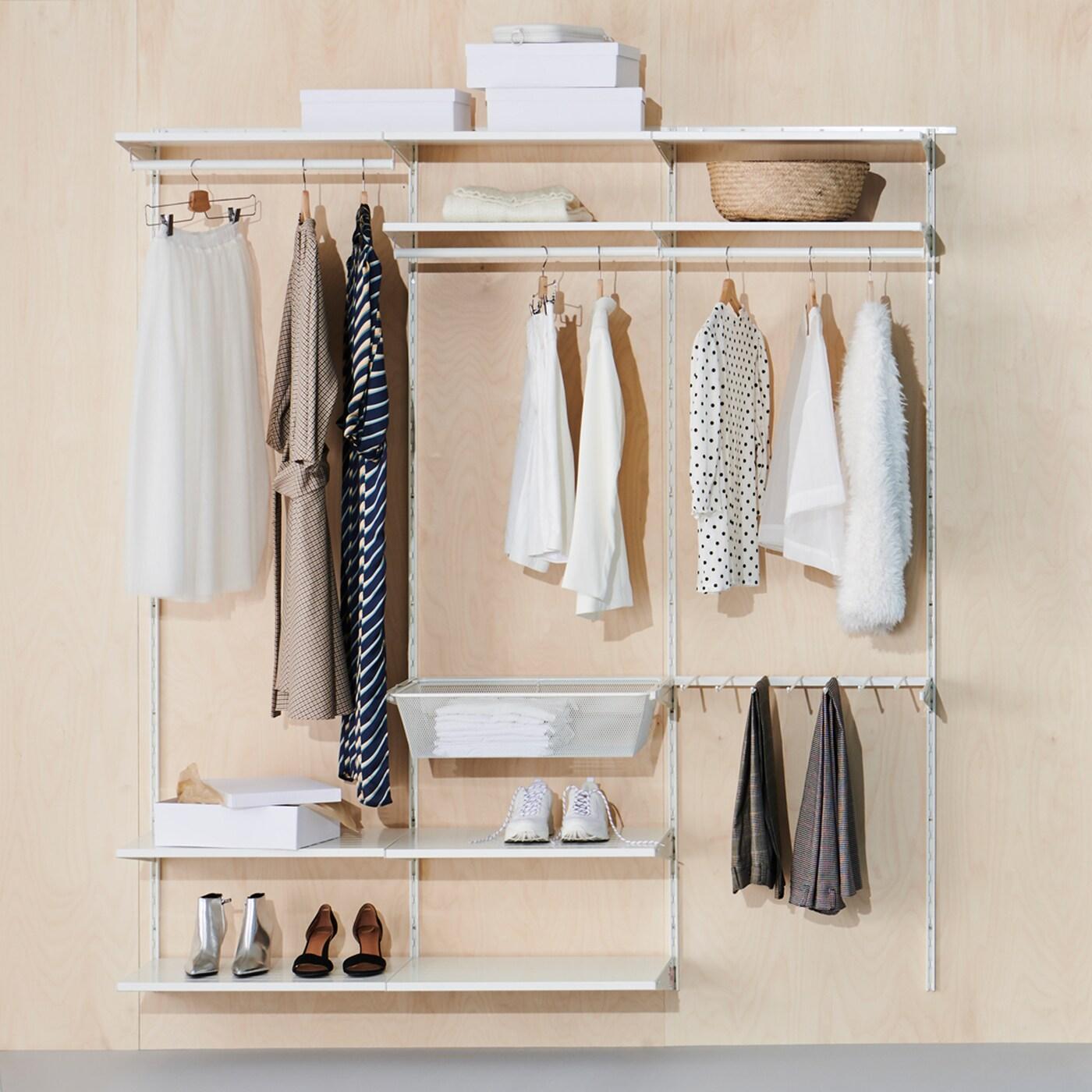 Combinaison d’armoire-penderie BOAXEL avec tablettes, tringles à vêtements et corbeille en fil, où sont rangés des vêtements, des chaussures, des boîtes et un panier.