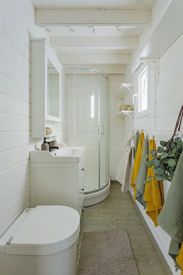 Compact bathroom with shower, sink, and modern decor