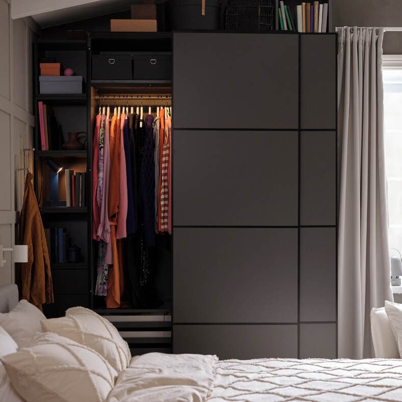 Compact bedroom featuring a sliding door wardrobe and open storage shelf