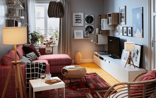 Compact living room with a sofa bed with chaise longue on one side; sideboard, storage, TV, stereo and art on the other.