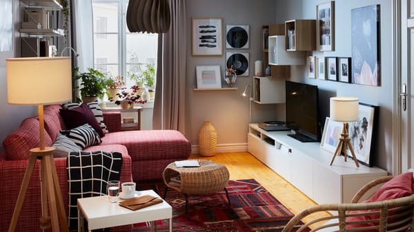 Compact living room with a sofa-bed with chaise longue on one side; sideboard, storage, TV, stereo and art on the other.