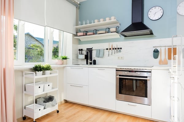 Compact modern kitchen with white cabinetry, marble backsplash and open shelving
