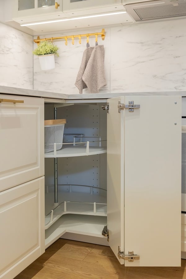 Corner kitchen cabinet with rotating shelves for practical storage solution.