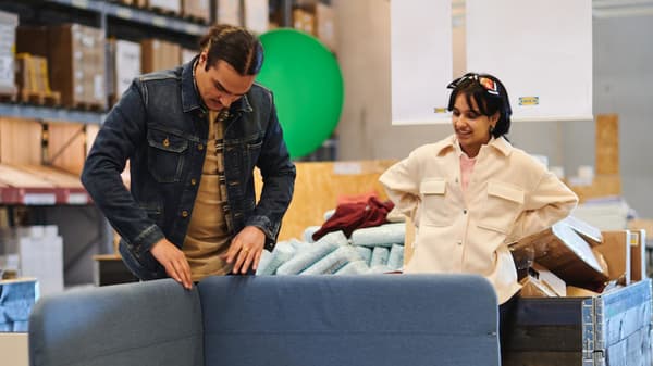 couple deciding what to buy from the As is section in ikea