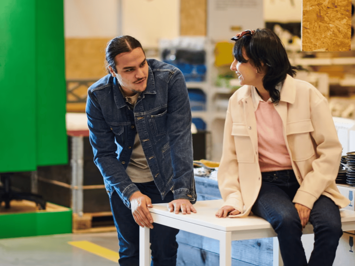 Couple sat on a table in the circular hub talking