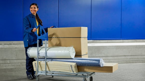Coworker with a trolley full of items.
