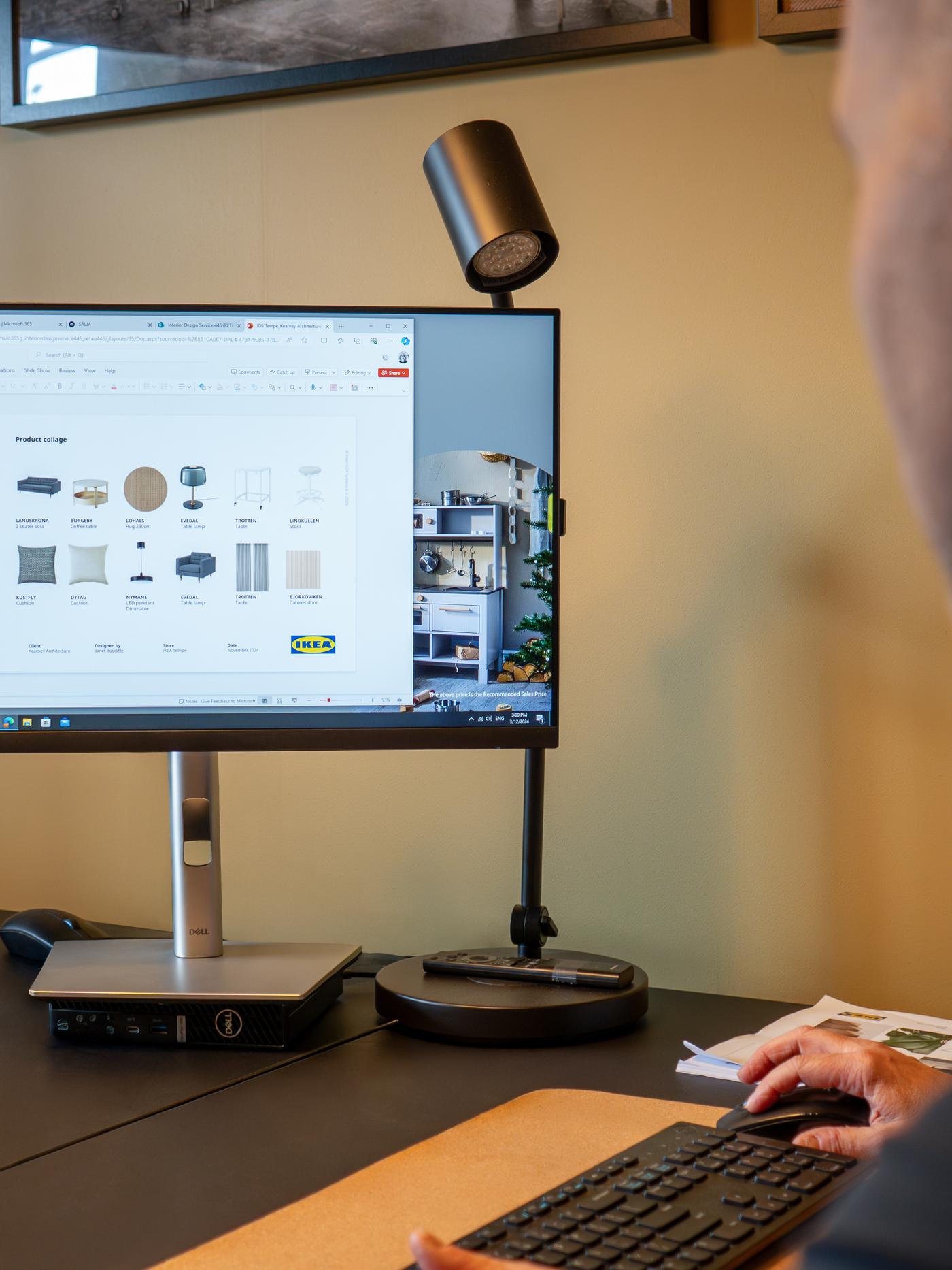 Coworker with business customer desigining their space on computer.