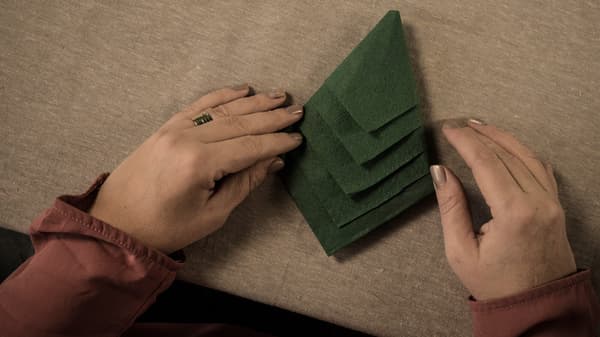 Crafting instructions, step 5: When you have folded in all the edges, you have the shape of a fir tree. 