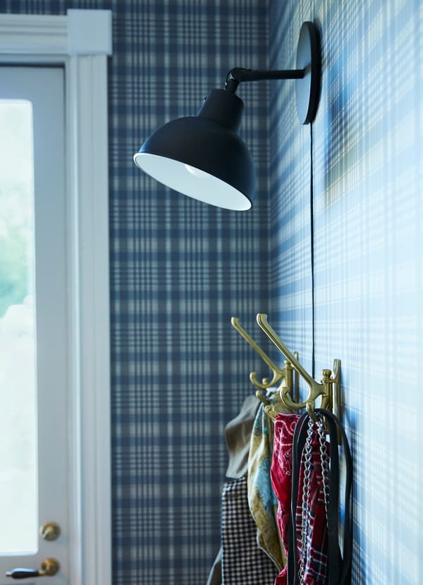 Create a hook hanging storage station with IKEA KAMPIG brass swivel hooks and SKURUP mounted black wall lamp. There are three hooks in each to hold more.