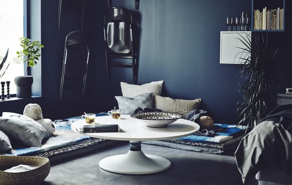 Create a low-level dining and entertaining space with some mattress and cushions on the floor and a DIY low-level table hack.