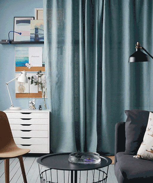 Create a permanent art wall that you can hide behind a curtain when you’re not using it, such as IKEA LEJONGAP curtains in a dull green hue.