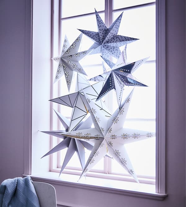 Create a warm glow in your dining room window this holiday with Christmassy stars. IKEA has lots of lamp shades such as STRÅLA lamp shade in silver or white with a snowflake motif.