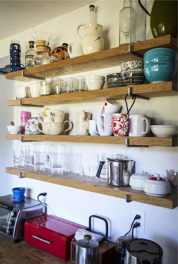 Crockery stored on open shelves.