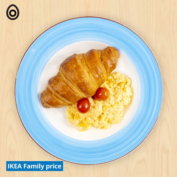 Croissant, scrambled egg and tomatoes with egg food symbols at top left corner.  A 'IKEA Family price' tag on the bottom left.