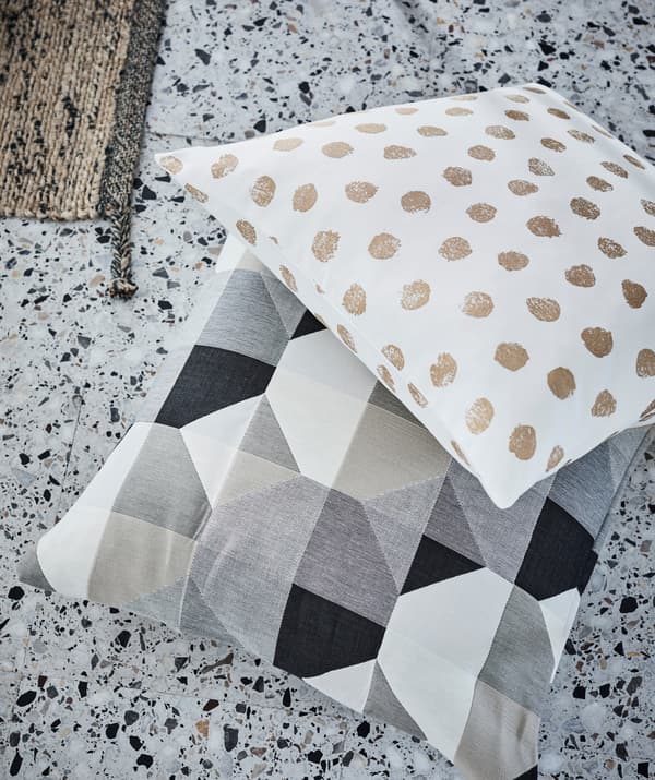 Cushions with simplistic, strong dot or block patterns create a splash wherever they land – even on terrazzo floor tiles.