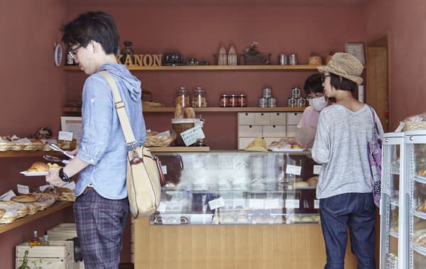 Customers choosing breads and cakes in the bakery