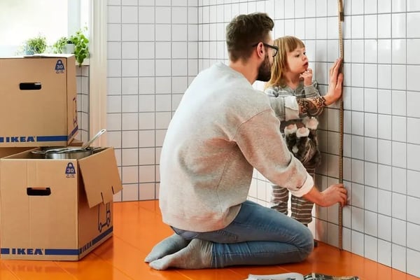 Dad and child measuring wall