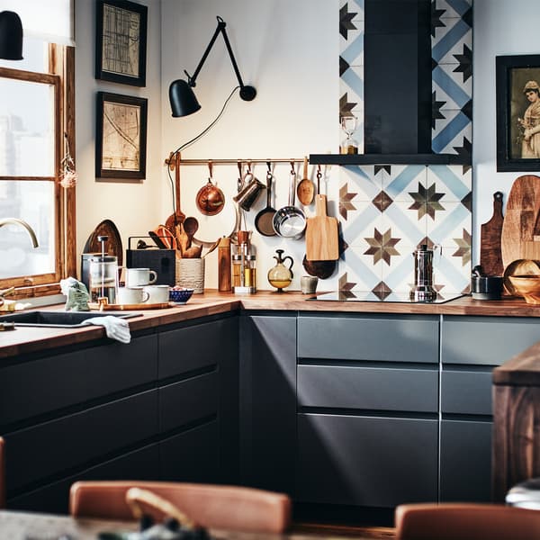 Dapur METOD moden dengan bahagian hadapan berwarna kelabu gelap dan permukaan kerja kayu dengan dinding dapur jubin dapur.