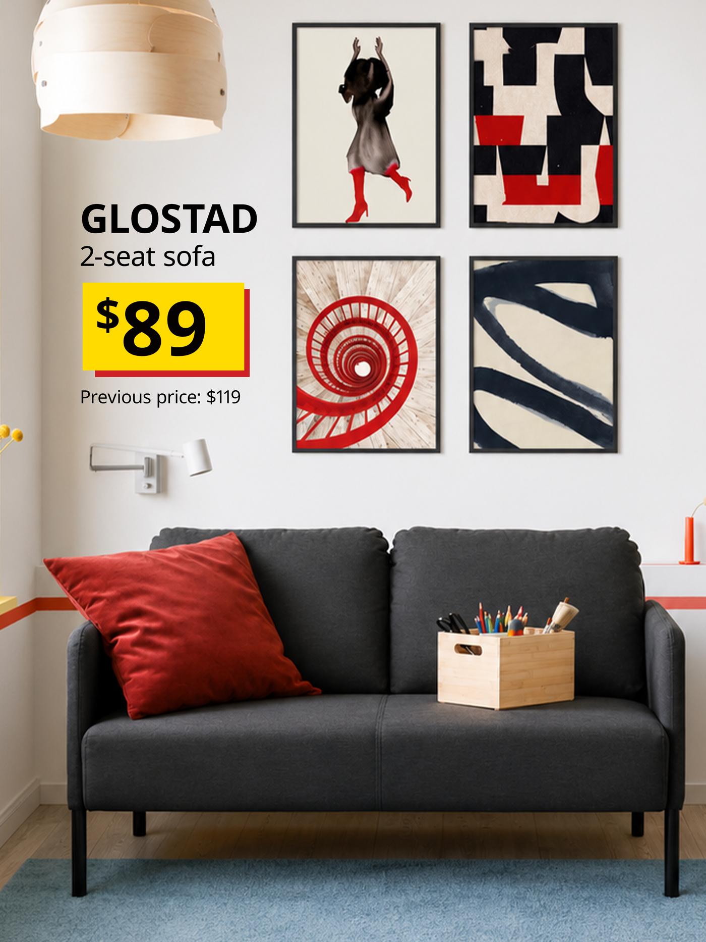 Dark grey GLOSTAD 2-seat sofa styled with red cushions
