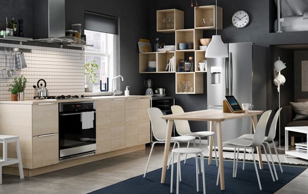 Dark grey kitchen with light wood open and closed cabinets.