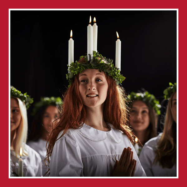 Das Bild zeigt eine Lucia Sängern, mit dem traditionellen Kranz im Haar.
