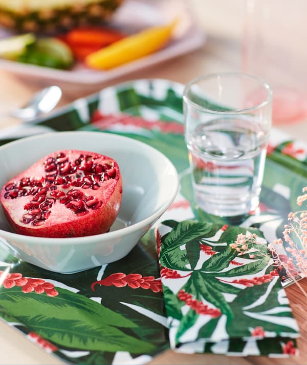 Deo stola s prepolovljenim narom u beloj činiji, na crvenom i zelenom SOMMARLIV poslužavniku, s odgovarajućom salvetom.