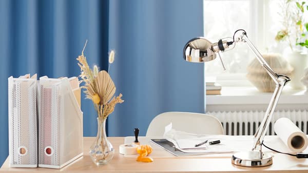 desk lamp on desk with office supplies