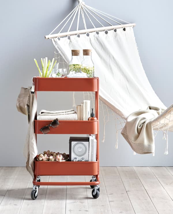 Desserte RÅSKOG utilisée pour transporter boissons, livres et musique de relaxation.