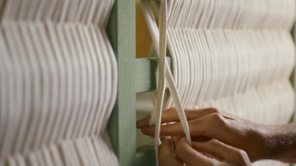 Detalhe de uma cama TARVA pintada de verde e com trapilho a decorar