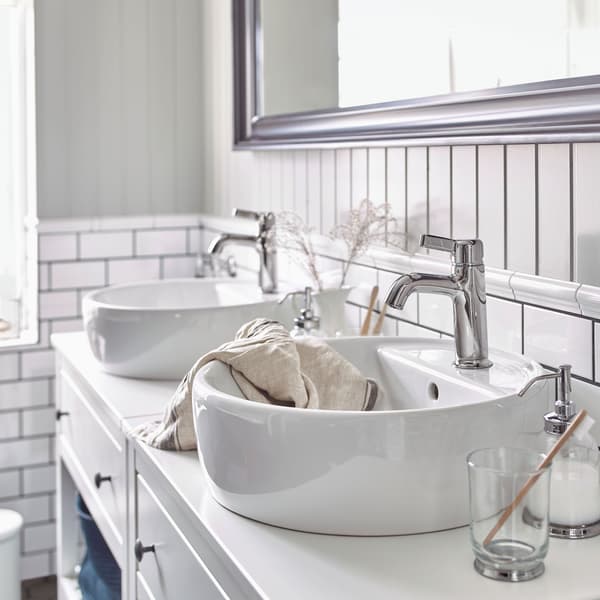 Deux meubles lavabo blancs IKEA HEMNES ouverts avec lavabos céramique IKEA TÖRNVIKEN et mitigeurs chromés VOXNAN.