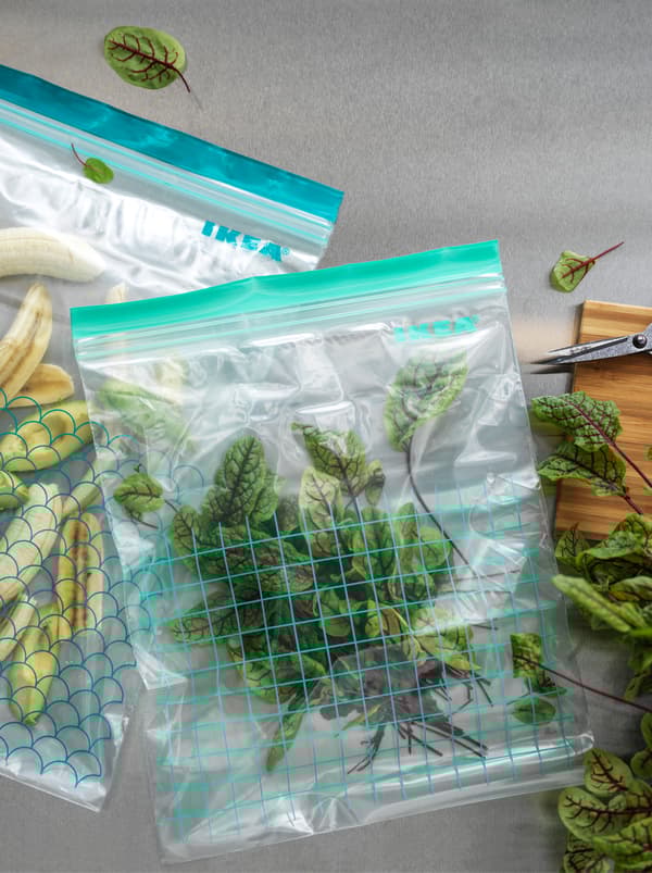 Deux sacs refermables en plastique ISTAD de tailles différentes, remplis de fruits et de légumes.