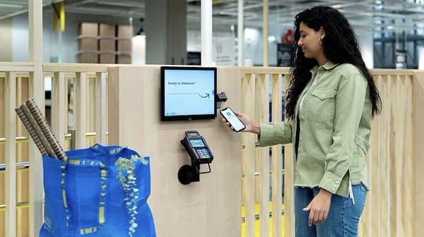 Donna che utilizza uno smartphone in un negozio IKEA.