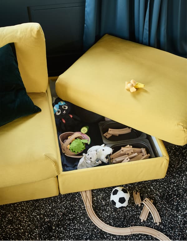 Double-function furniture looks good and works as storage for the whole family. One of the sofa sections (VIMLE) from IKEA is a chaise lounge with built-in storage. The footstool provides the kids with space for their own hidden toy stash!