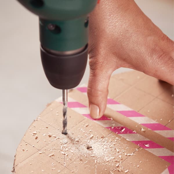 Drill small cross-stitch holes into the seat, using a pre-drawn template (see box).