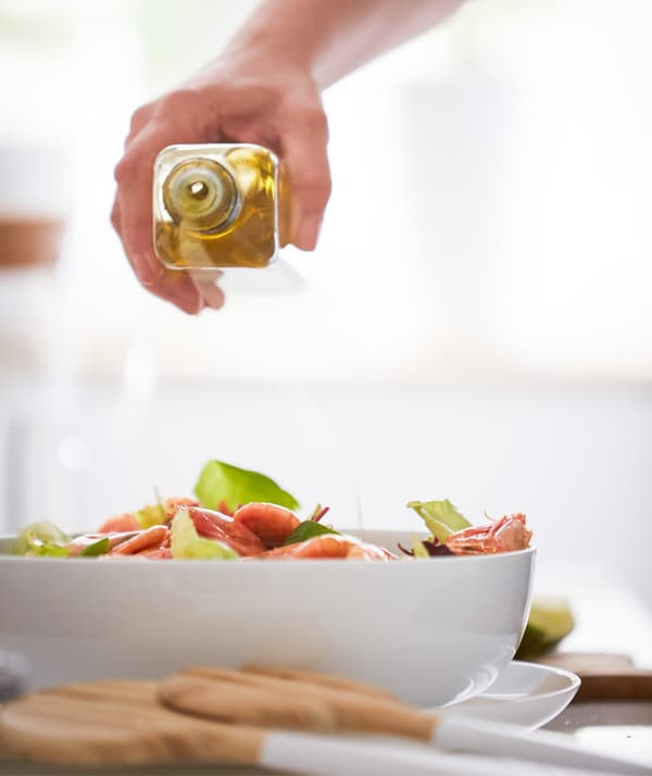 Drizzle the salad with oil.