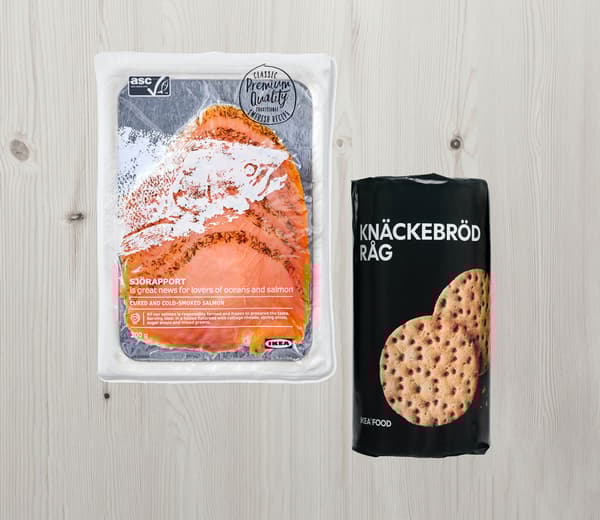 Du saumon gravlax fumé à froid SJÖRAPPORT et des pains croquants au seigle KNÄCKEBRÖD RÅG, ainsi que du bois en arrière-plan.