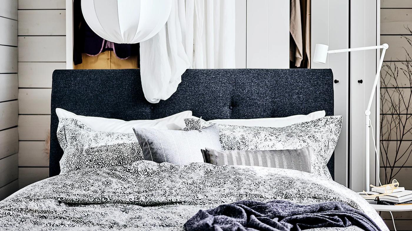 duże szare z łóżko z biało-czarną pościelą