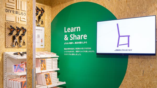 Educational area labeled 'Learn & Share' with DIY books, tools, and a screen showing how to build a chair.