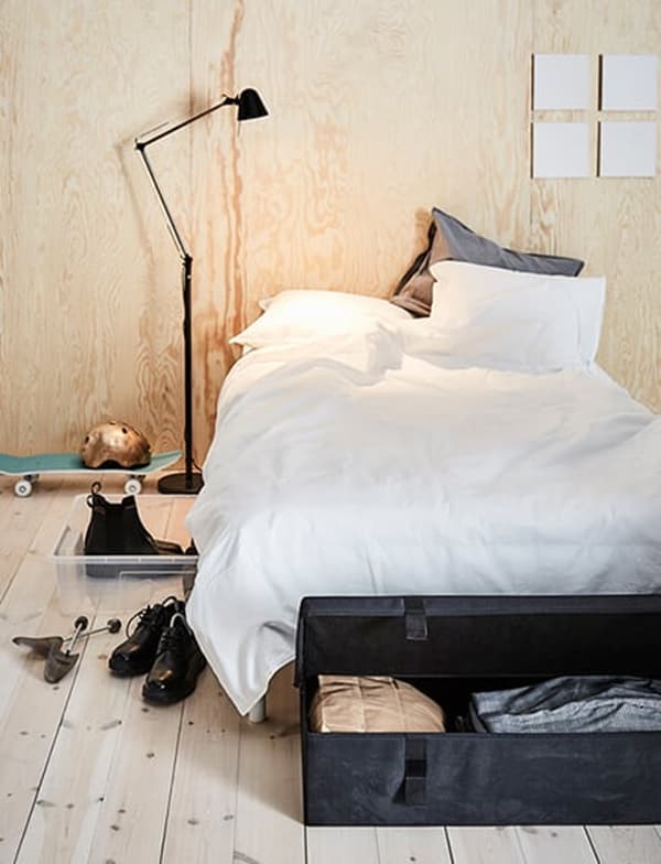 Eenpersoonsbed met daarnaast een lamp die op het bed schijnt.