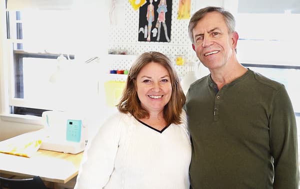 Eileen and her husband in her sewing studio where she teaches sewing and art classes