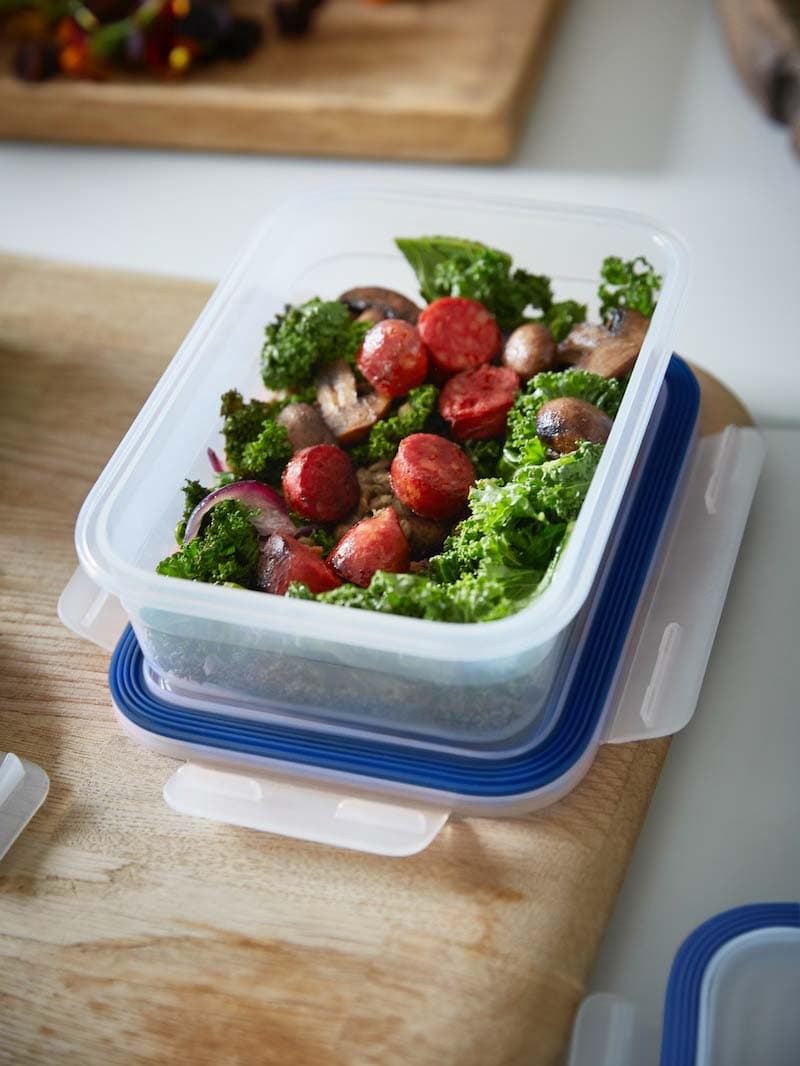 Ein IKEA 365+ Vorratsbehälter, der als Mehrwegbehälter verwendet werden kann, ist mit Essen gefüllt. Darunter liegt der passende Deckel.