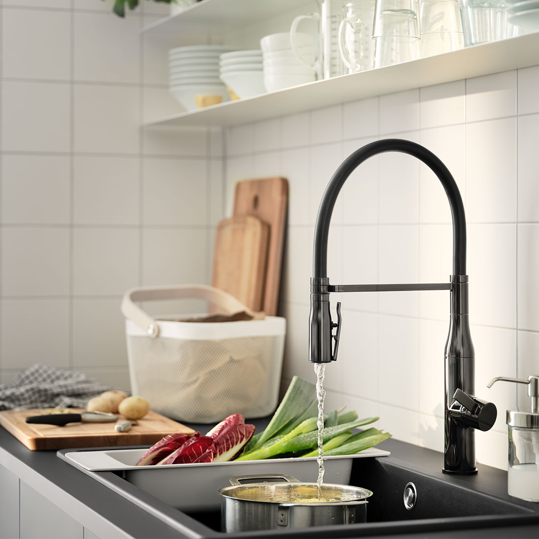 Ein schwarzes Waschbecken mit einer schwarzen Mischbatterie in der Küche, um Wasser zu sparen.