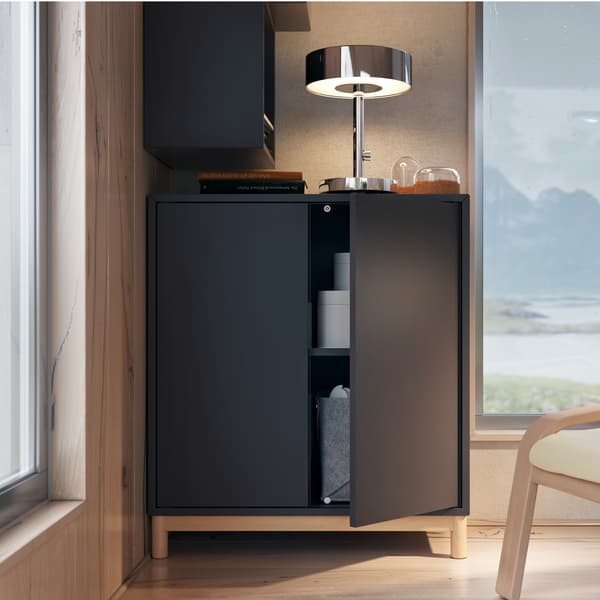 EKET dark grey cabinet combination with legs and movable shelf, with a lamp on it and a window beside with a panoramic view.