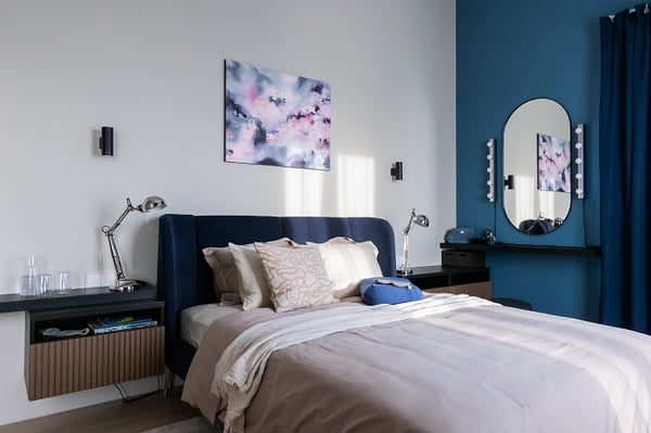 Elegant bedroom detail with upholstered bed, bedside tables, and soft textiles