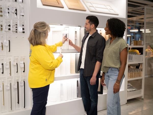 Employee in yellow shirt consulting customers