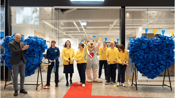 En gruppe IKEA medarbejdere i deres uniform og maskotten FABER bjørn står på en rød løber ude foran Plan and Order Point Herning.