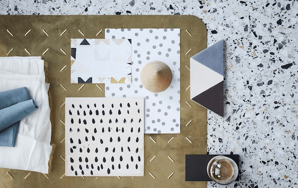 End-of-summer interior trends feature multiple examples of organic textures and graphic patterns. Here a mix of simple patterns with dots and blocks on paper and tiles, and notes of textiles, glass and brass.