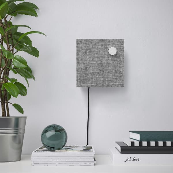 ENEBY Bluetooth speaker wall mounted against a gray painted wall.